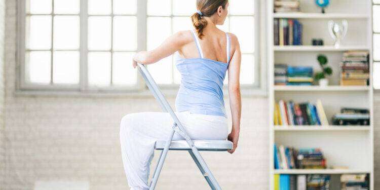 Lo yoga sulla sedia aiuta, ecco come si fa